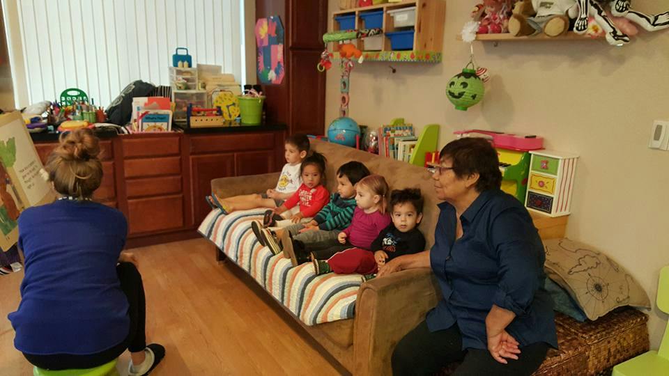 Person reading to children in a room