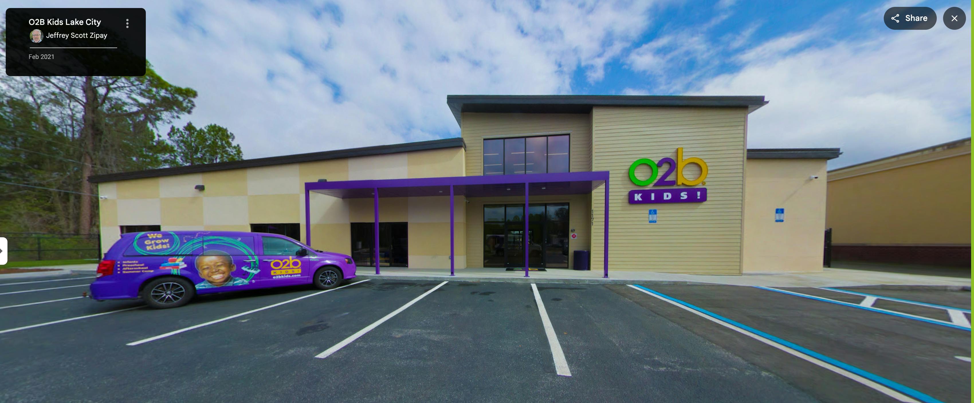 purple van with "We Grow Kids!" parked outside a building with "O2B Kids!" sign