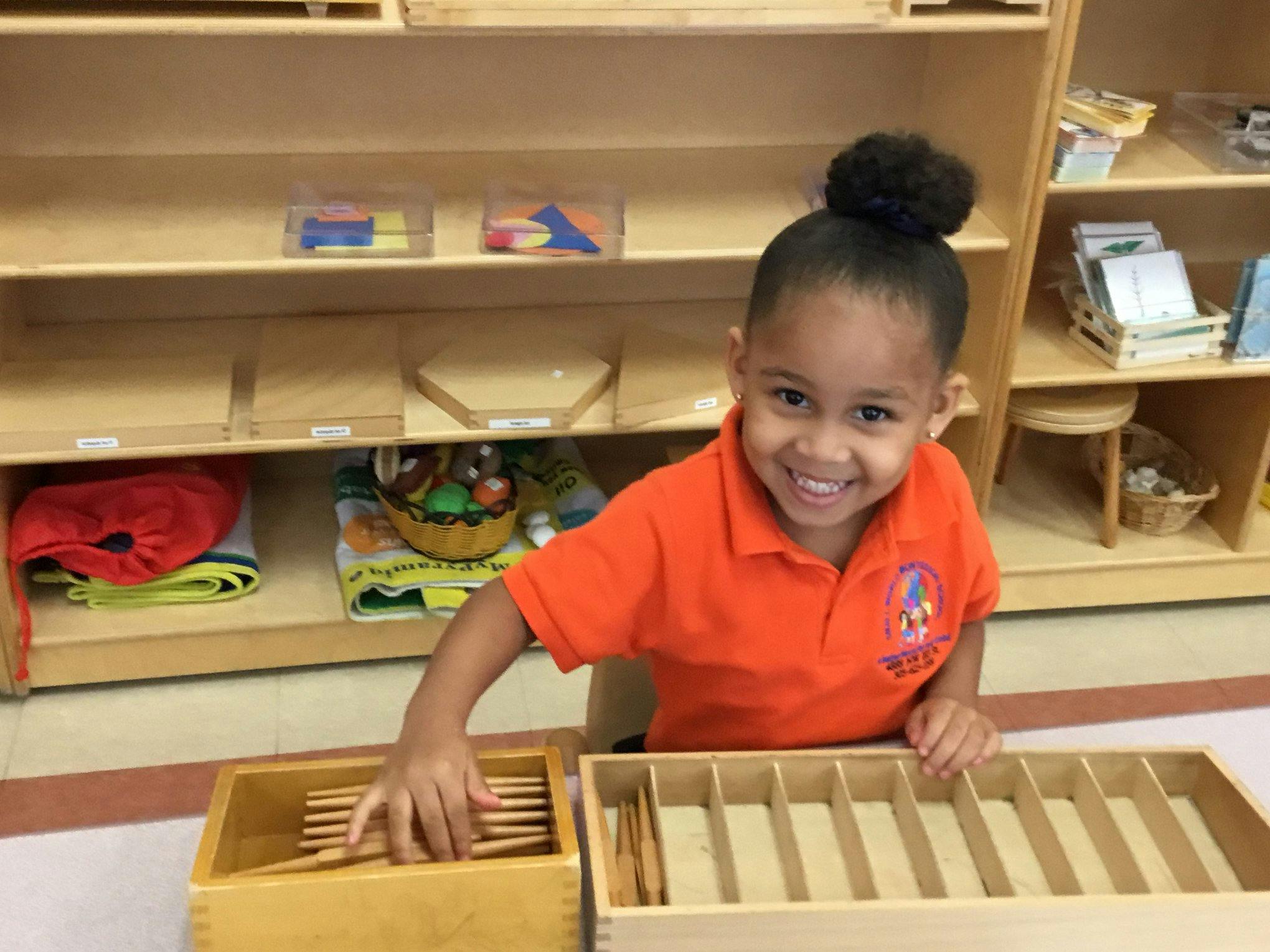Child playing with wooden blocks in a classroom