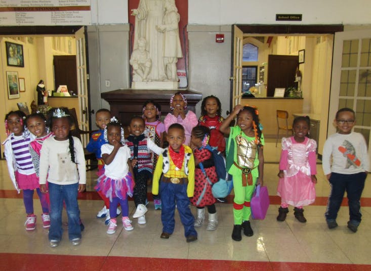 Group of children in costumes standing indoors