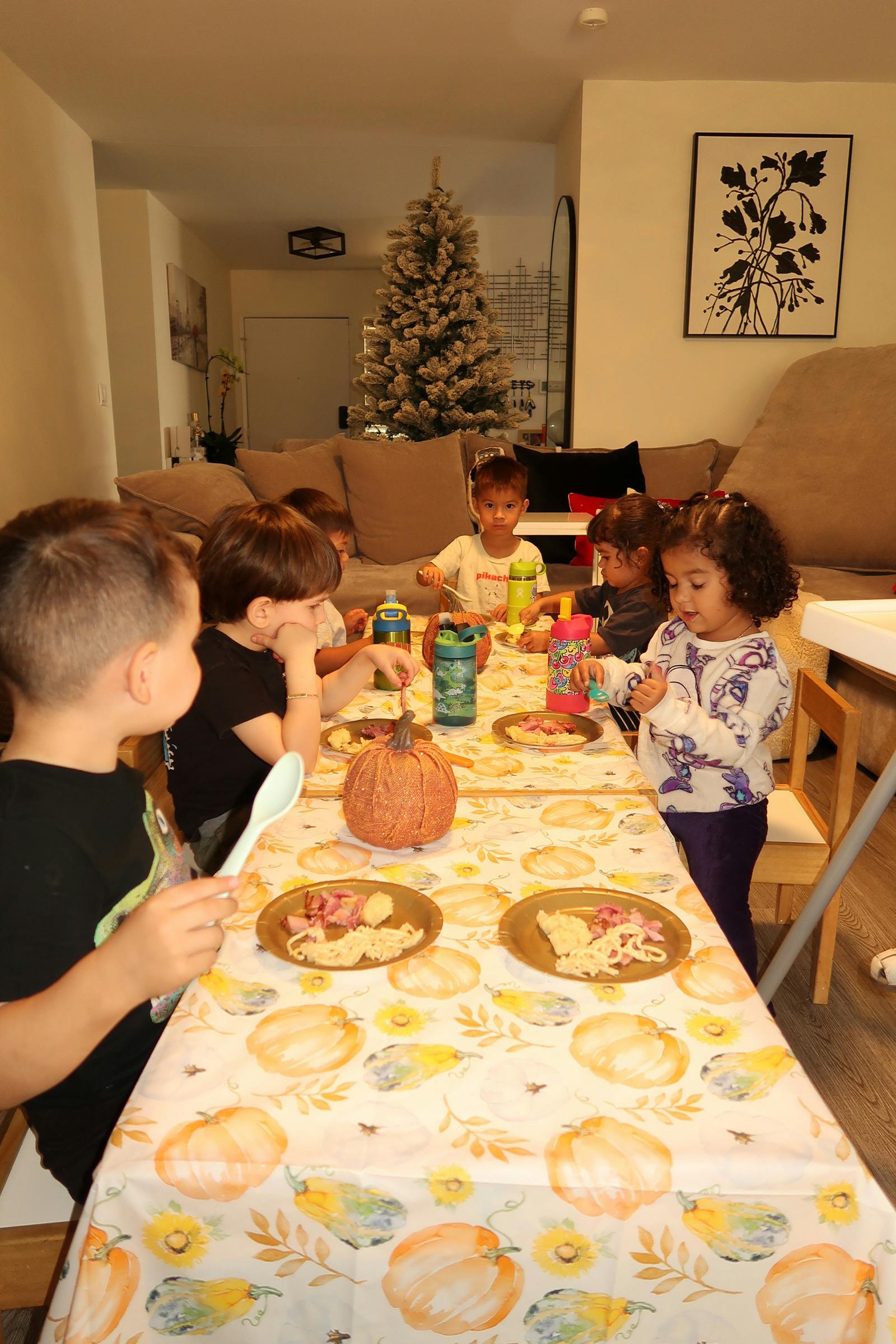 Children sitting around a table with plates of food