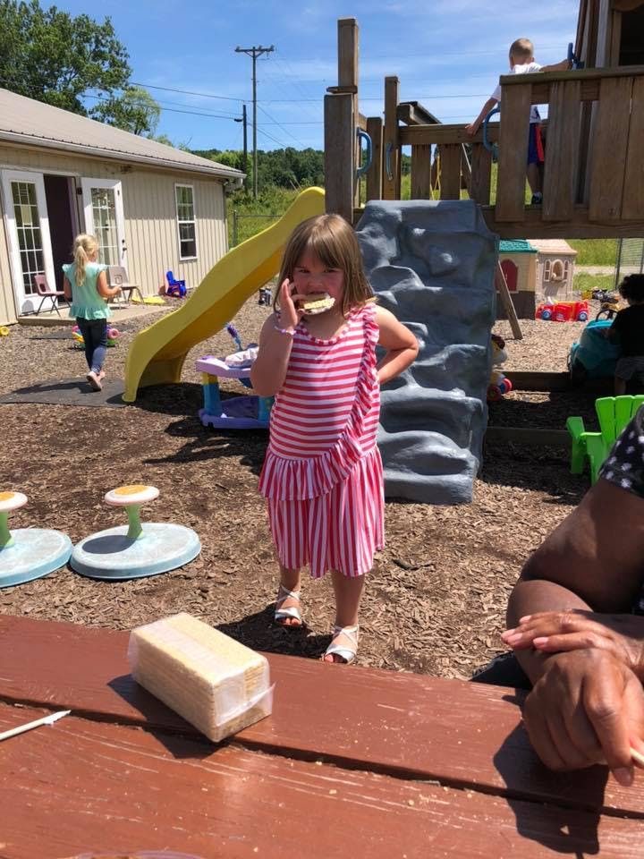 Child eating a snack on a playground