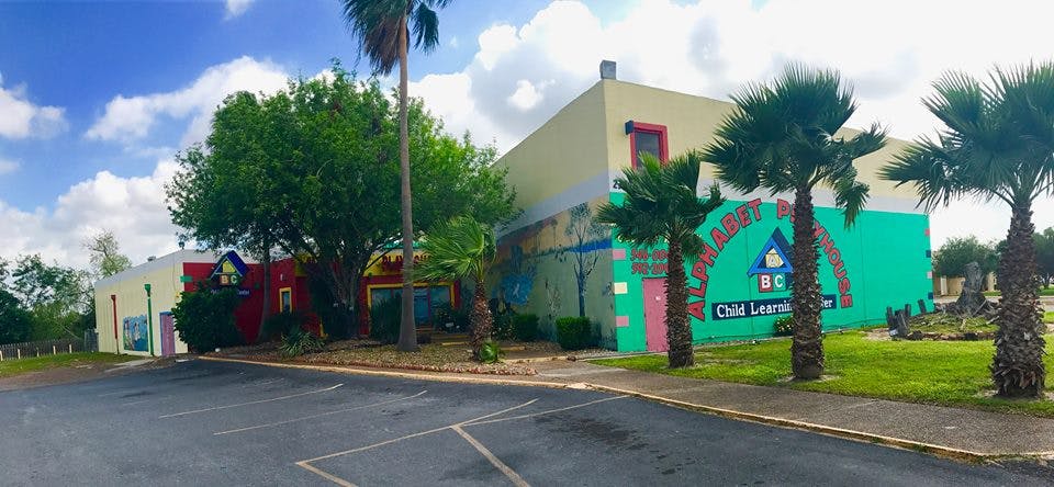 Building with a colorful mural and palm trees