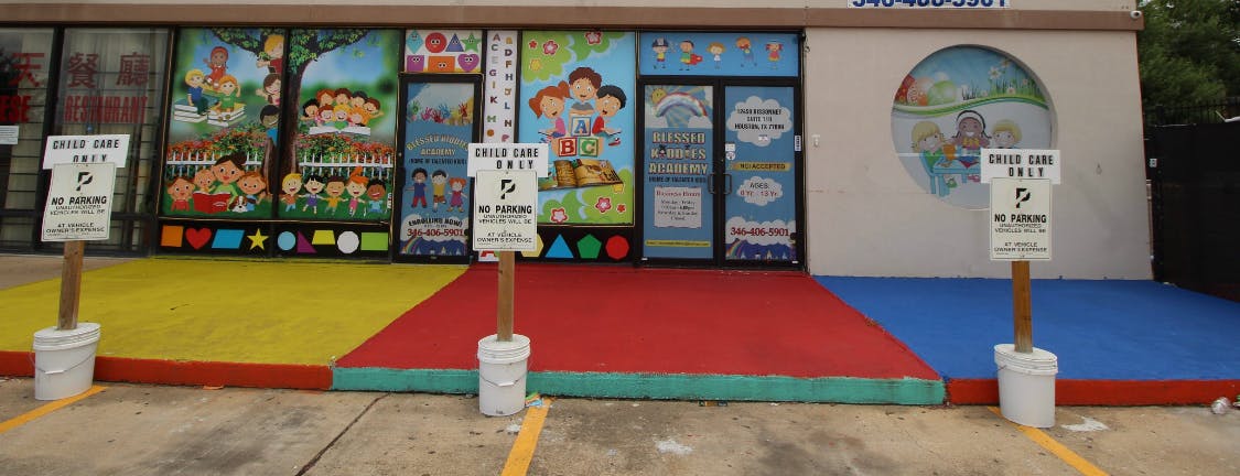 Building with colorful murals on windows and a painted entrance