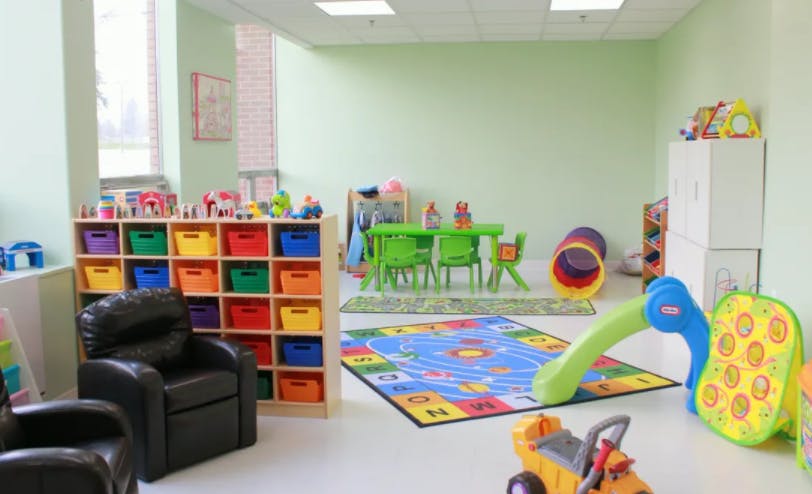 Playroom with colorful storage, small table and chairs, and play slide