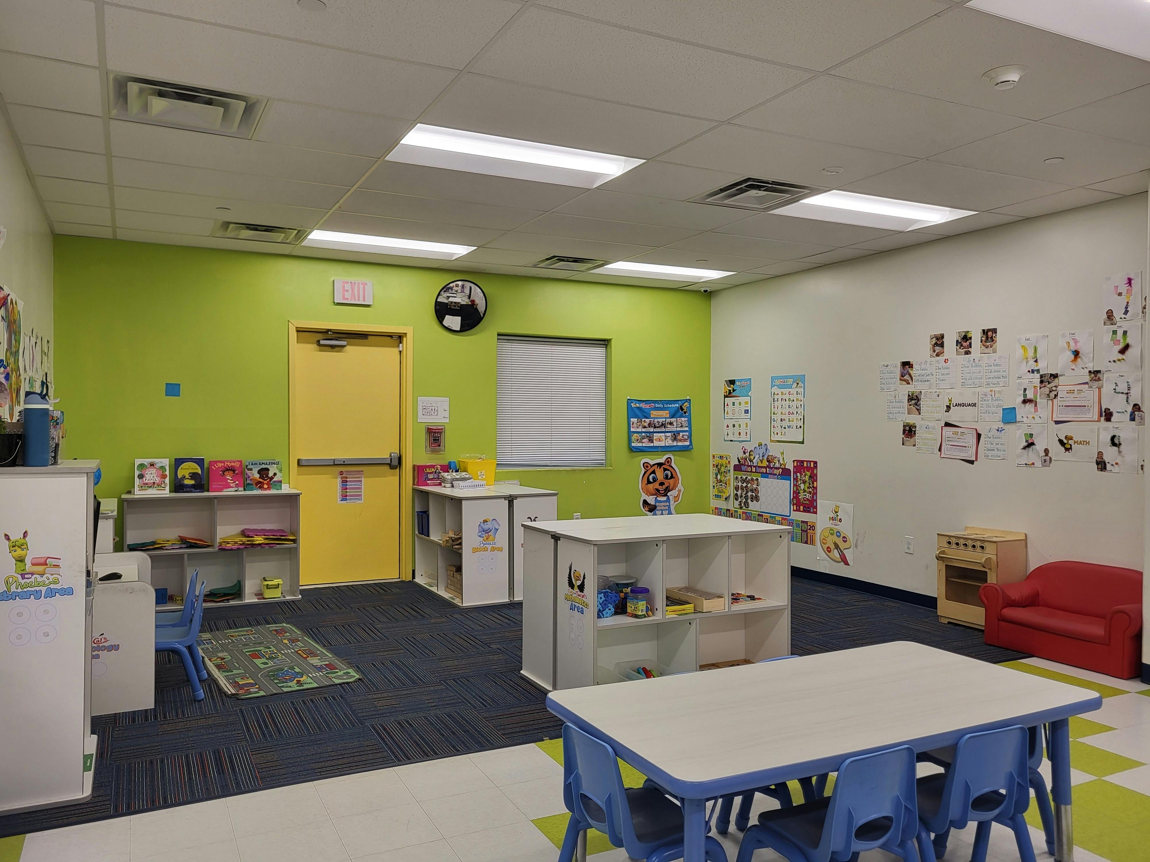 Empty classroom with tables, chairs, and shelves