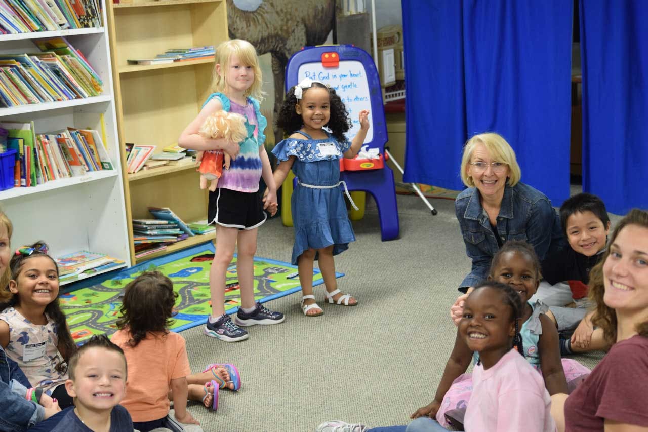 Adults and children gathered in a room
