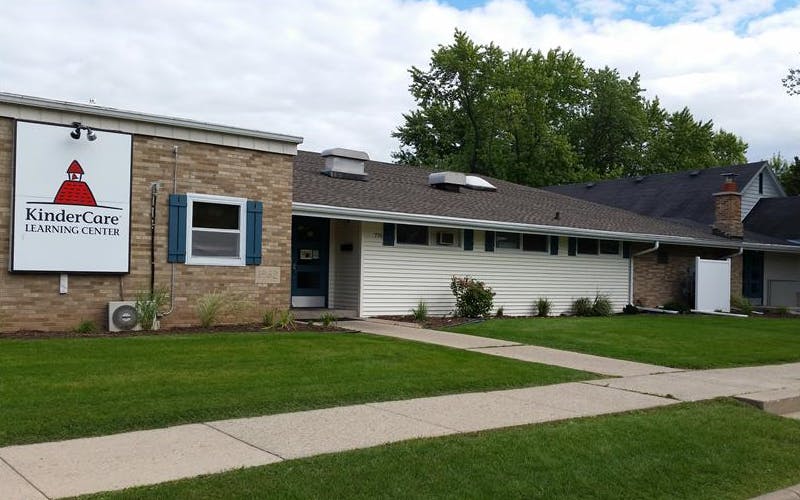 KinderCare Learning Center building with a sign and sidewalk