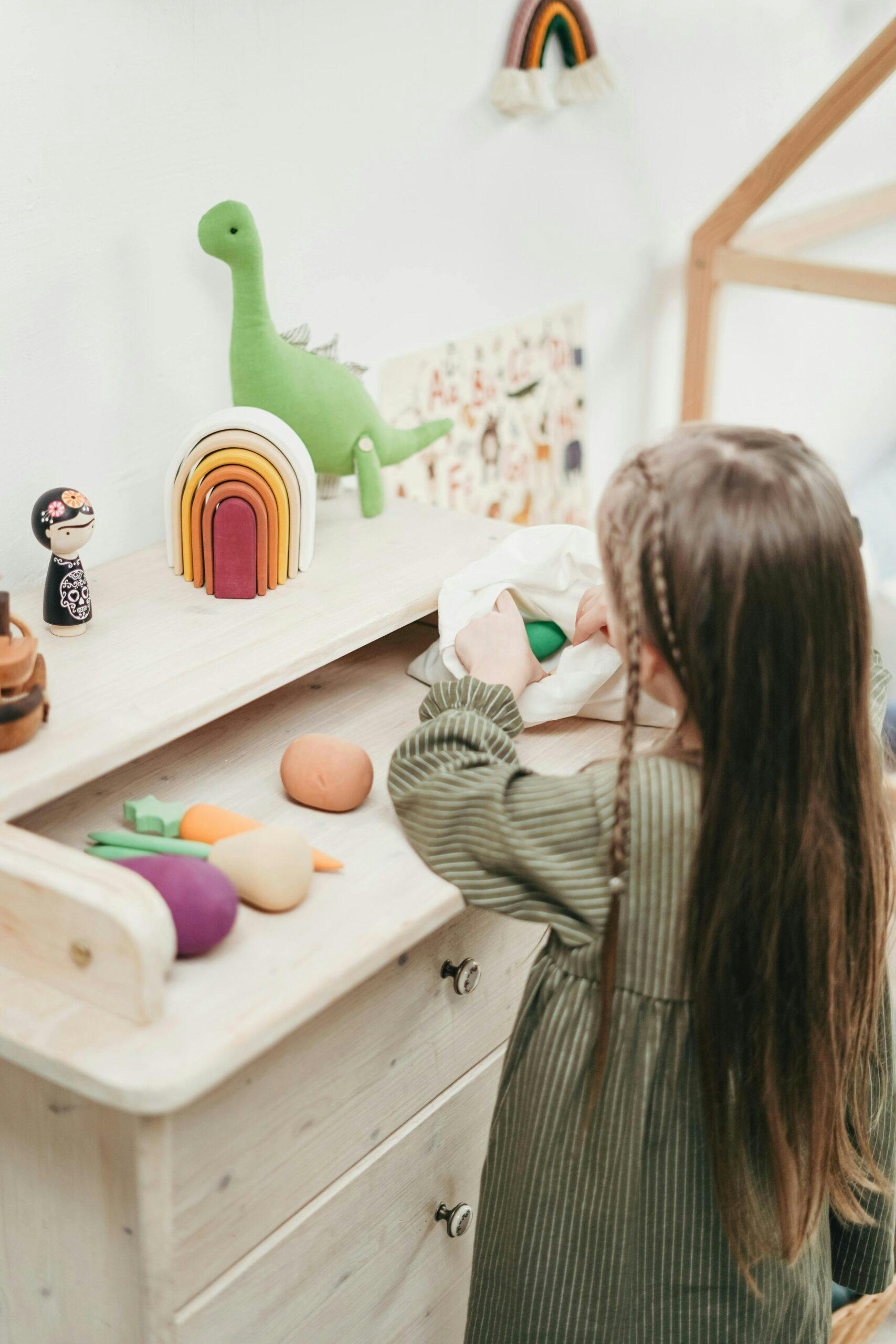 Child playing with wooden toys in a bedroom