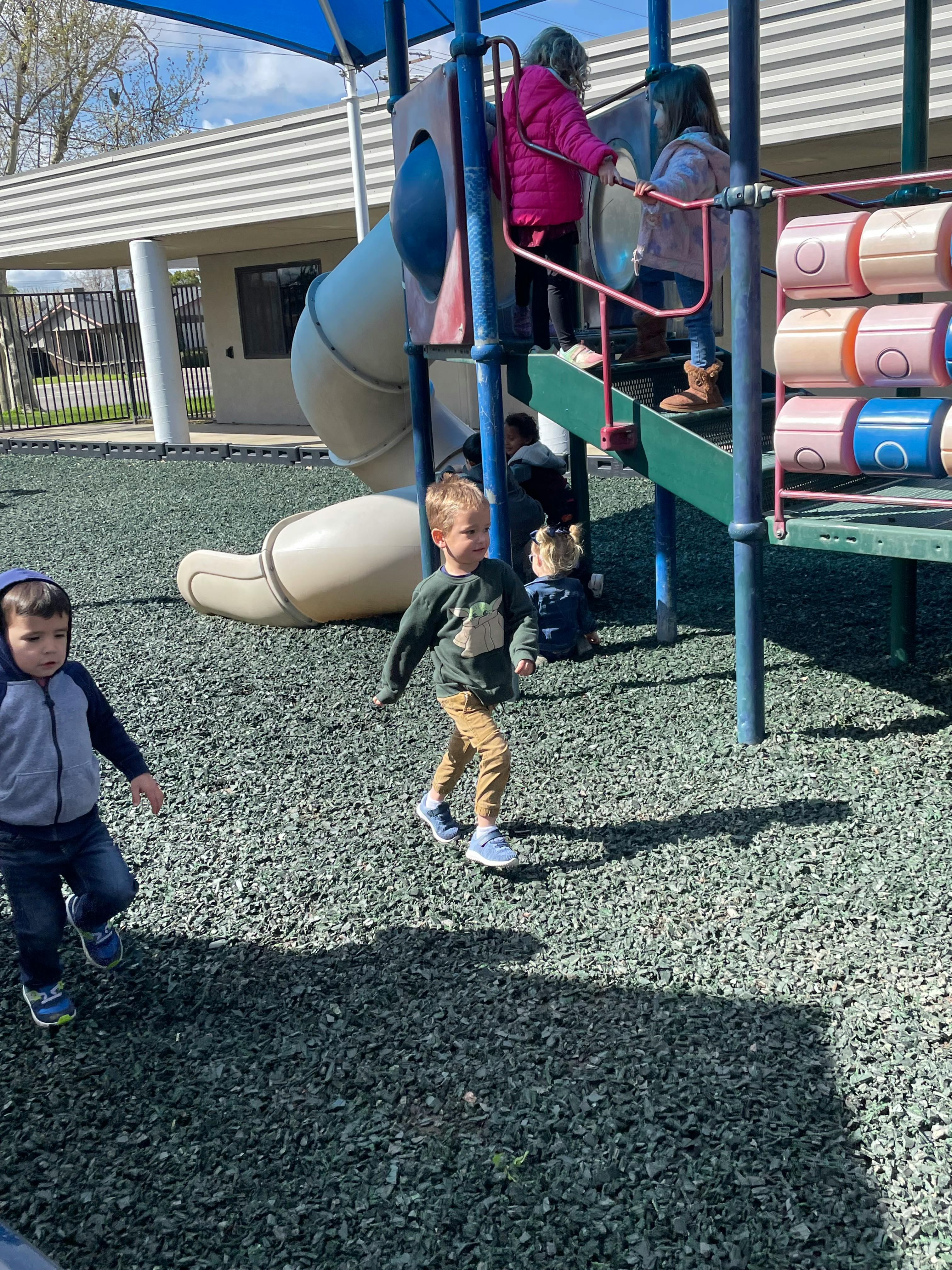 Children playing on a playground structure