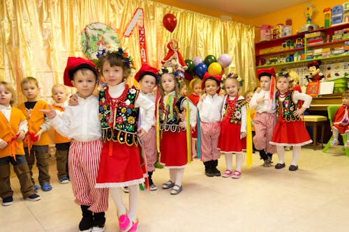 Children in traditional clothing standing in a room