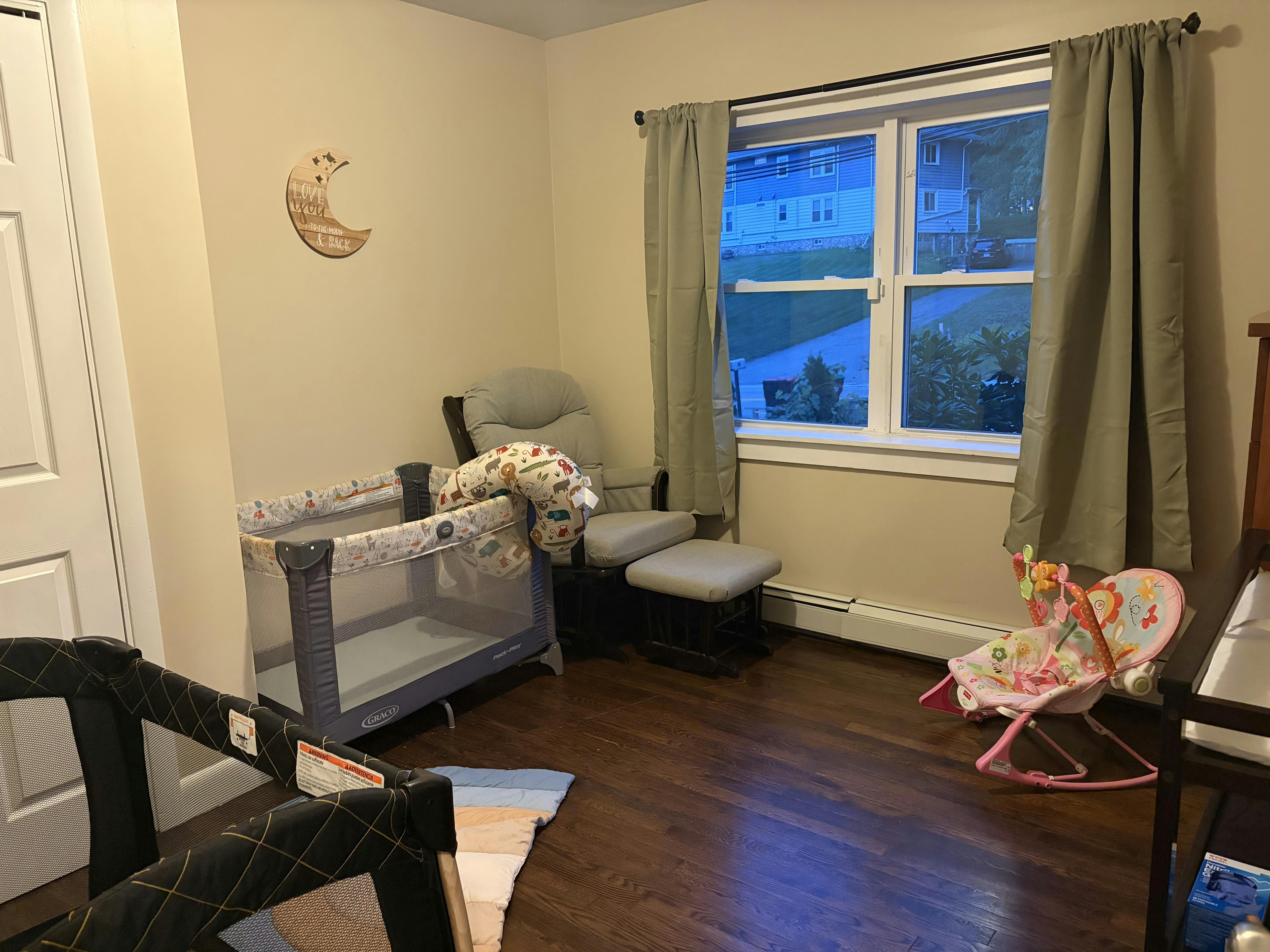 Nursery with playpens, rocking chair, and infant bouncer