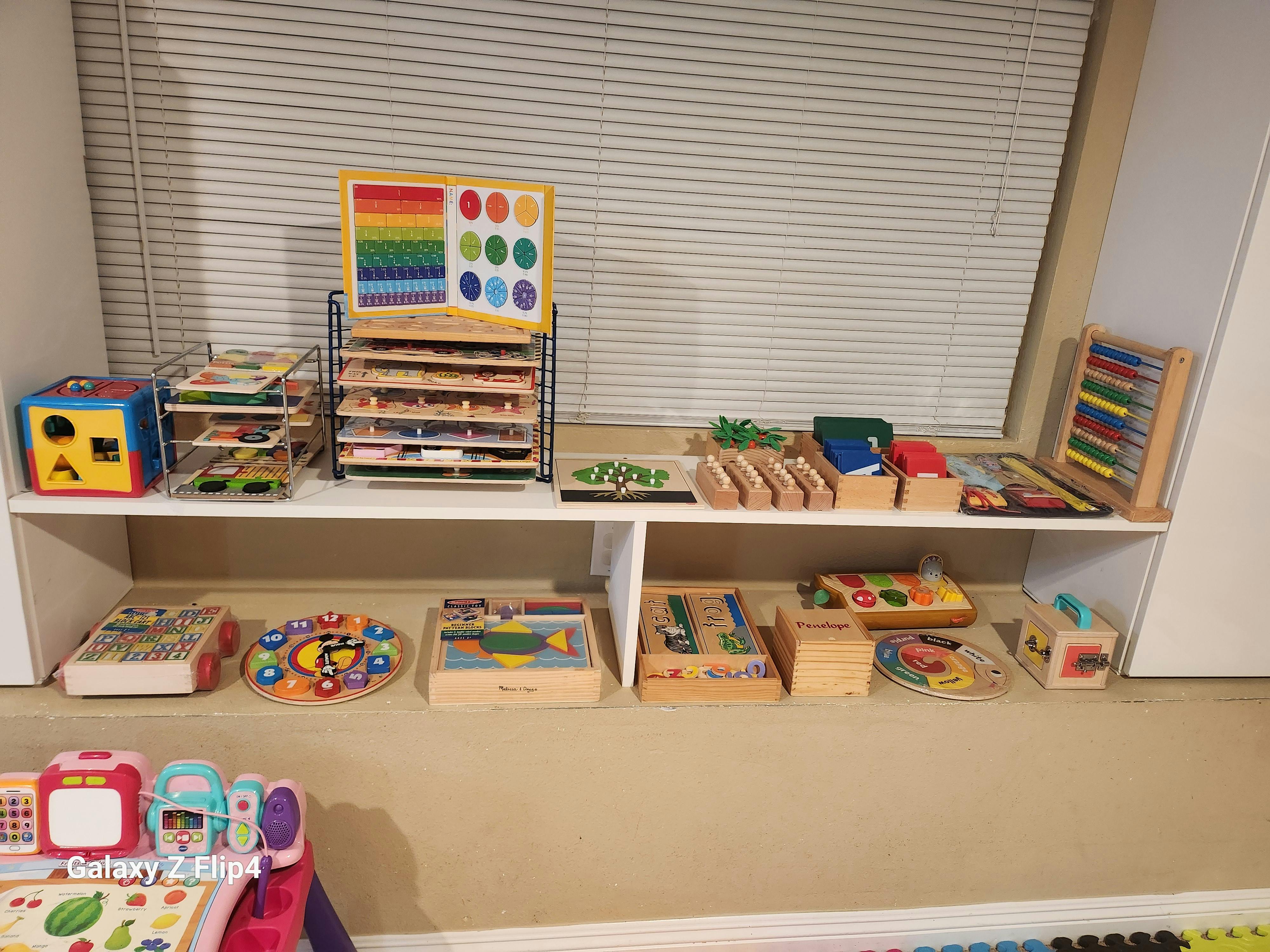 Wooden educational toys for children organized on white shelves
