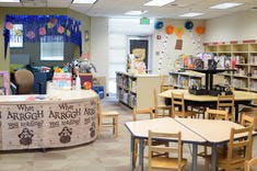 Children's library with tables, chairs, and bookshelves