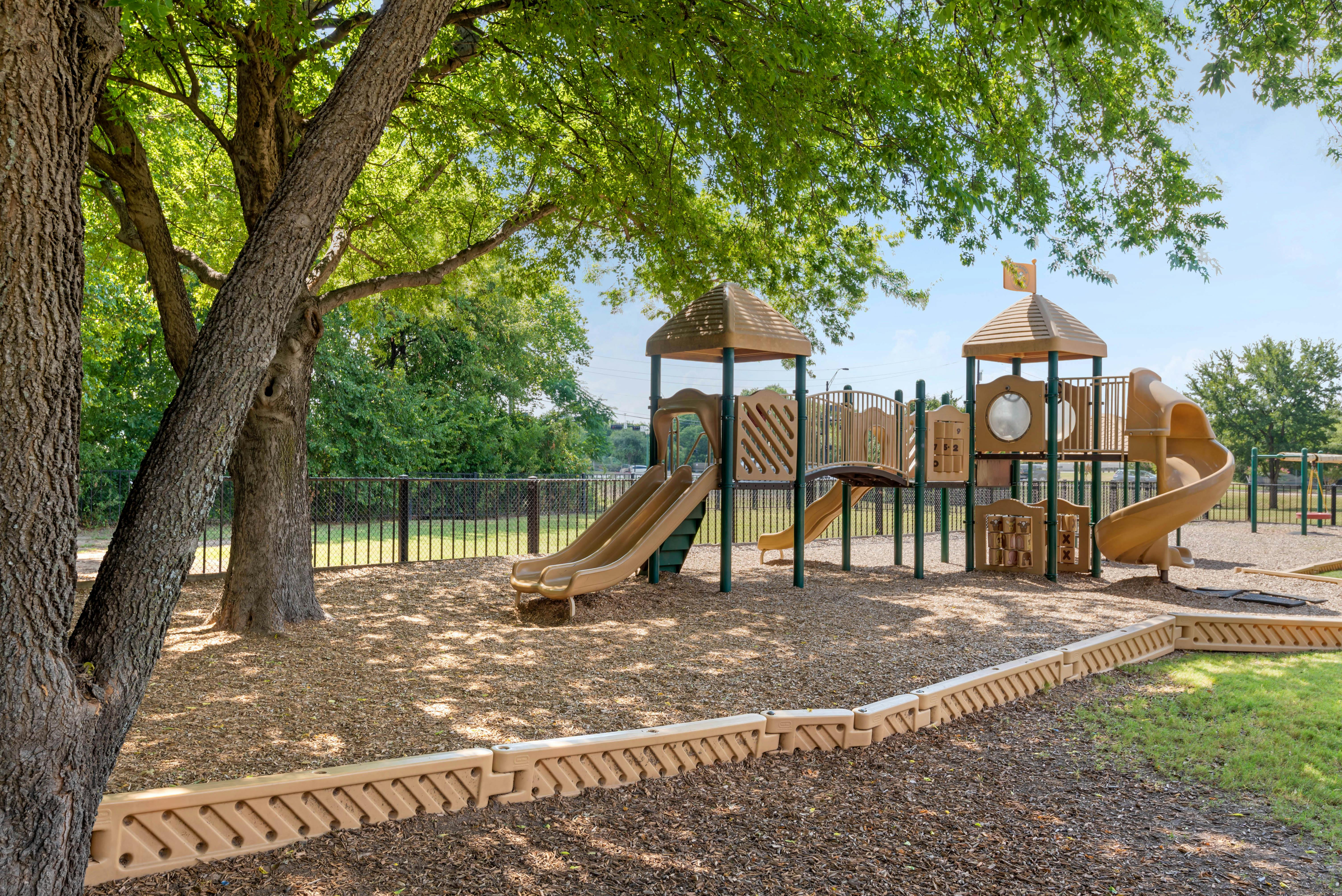 Empty children's playground with slides, bridges, and activity panels