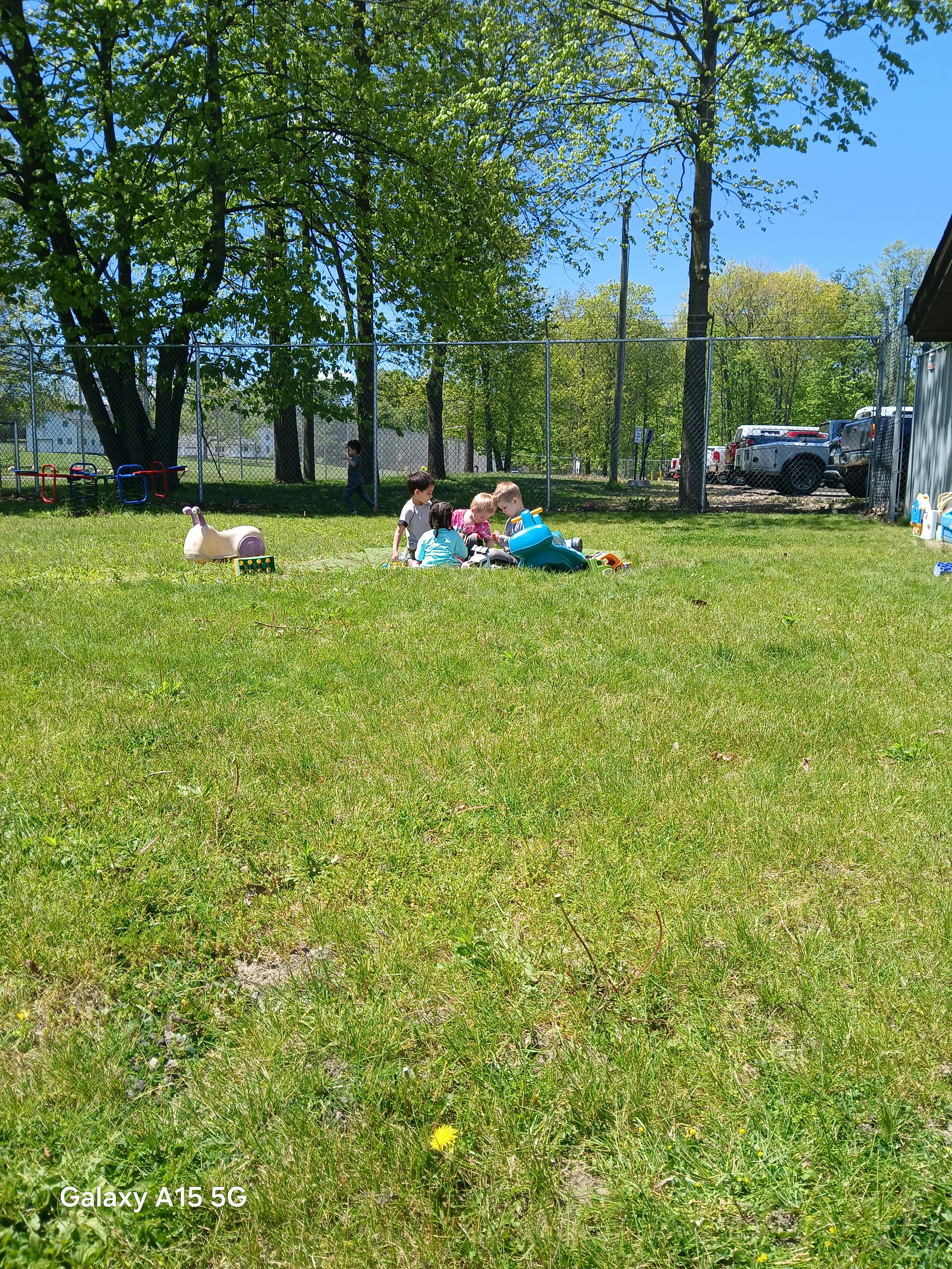 Children playing with toys on a grassy field