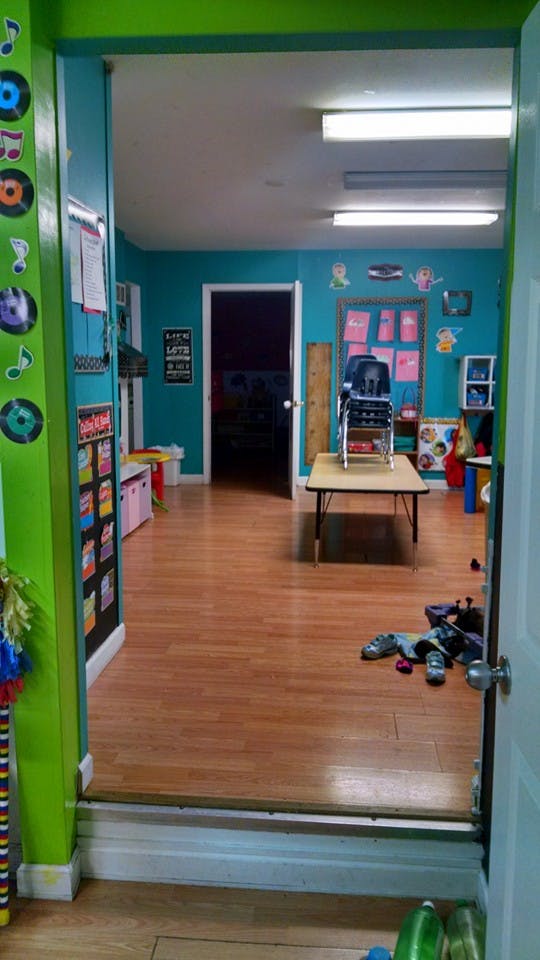 View into a classroom with blue walls and wooden floors