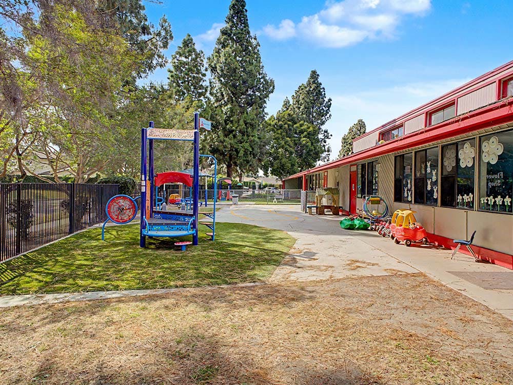 Playground equipment next to a school building