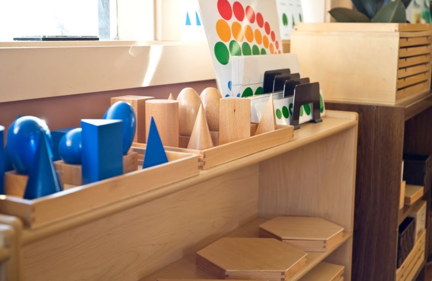 Geometric shapes in wooden trays on a shelf