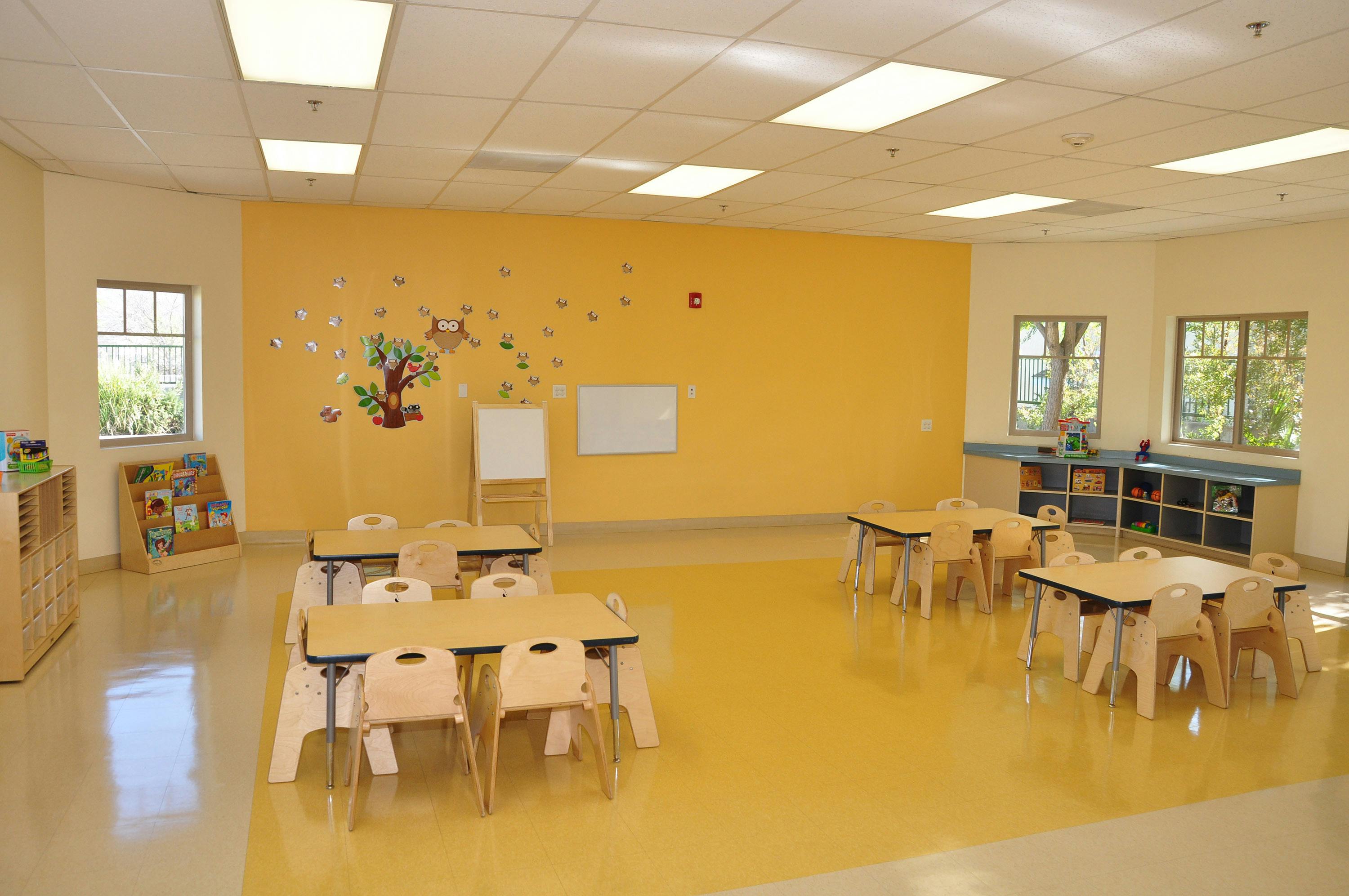 Empty classroom with small tables and chairs
