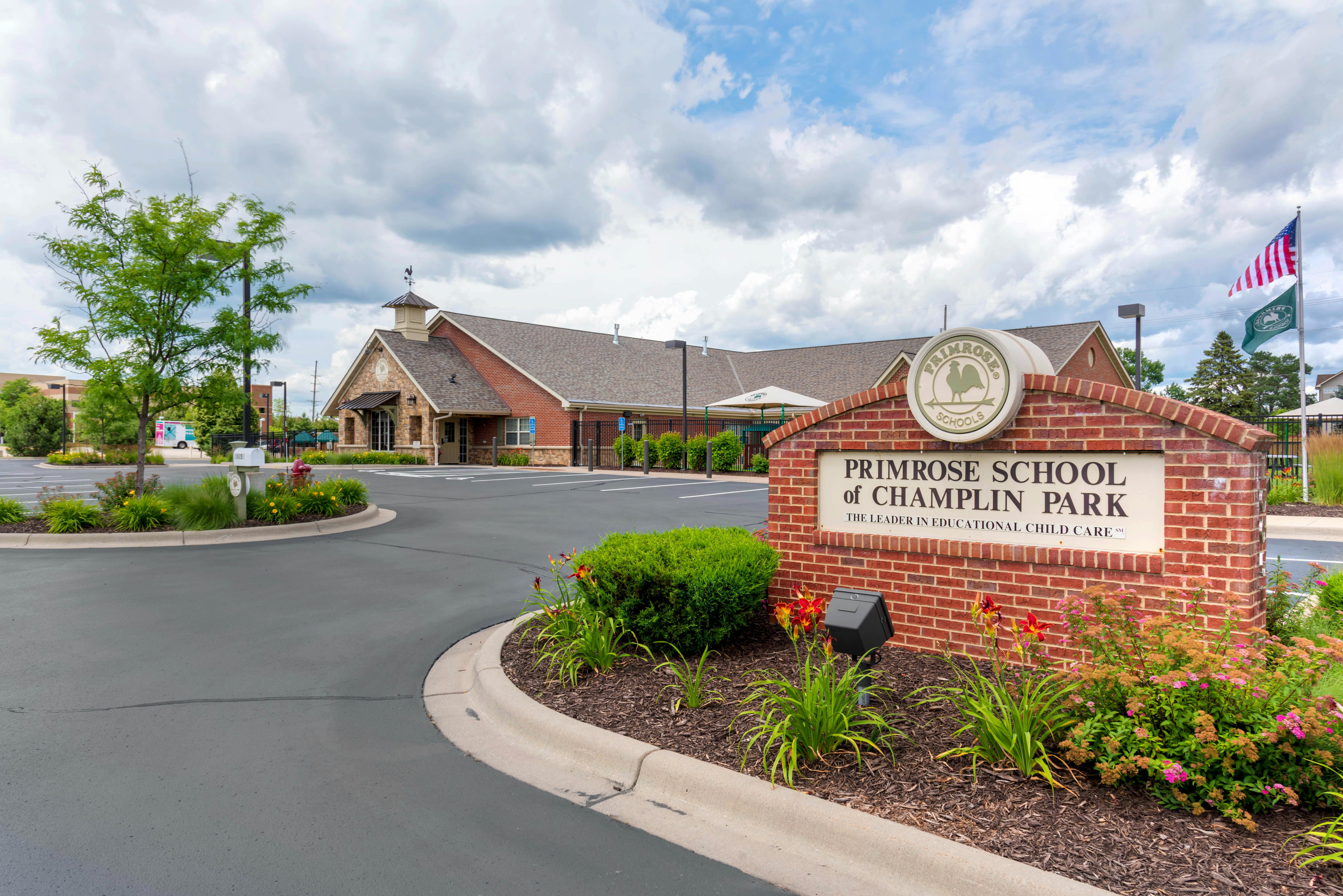Primrose School of Champlin Park sign next to a parking lot and building