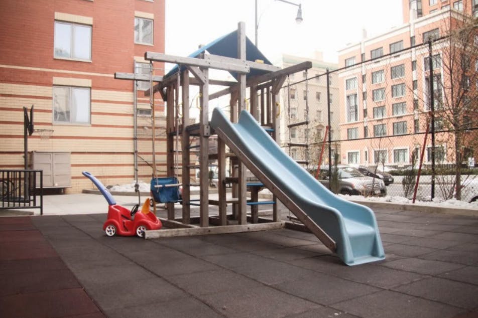 Playground with a slide and a red toy car