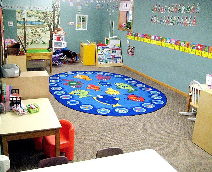 Classroom with a blue oval rug featuring cartoon fish