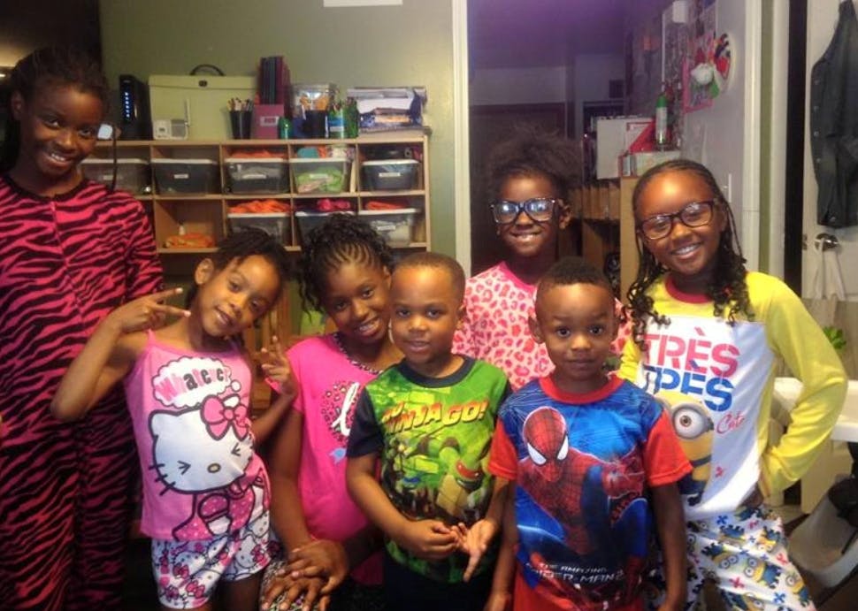 Group of children smiling and posing for a photo indoors