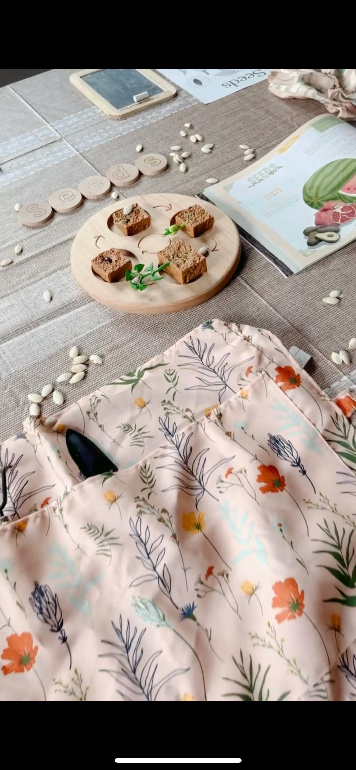 Four pieces of bread on a wooden board with seeds and a floral fabric