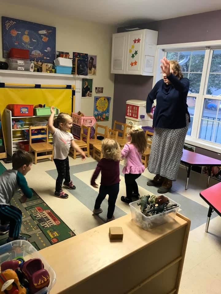 Adult and children in a classroom