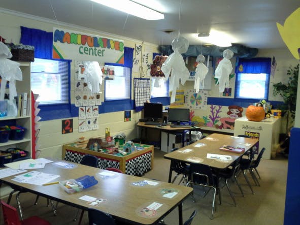 Classroom with tables, chairs, and decorations