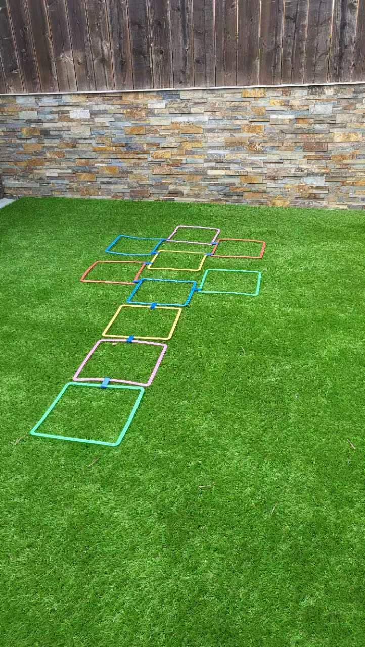 Colorful square hoops connected on artificial grass