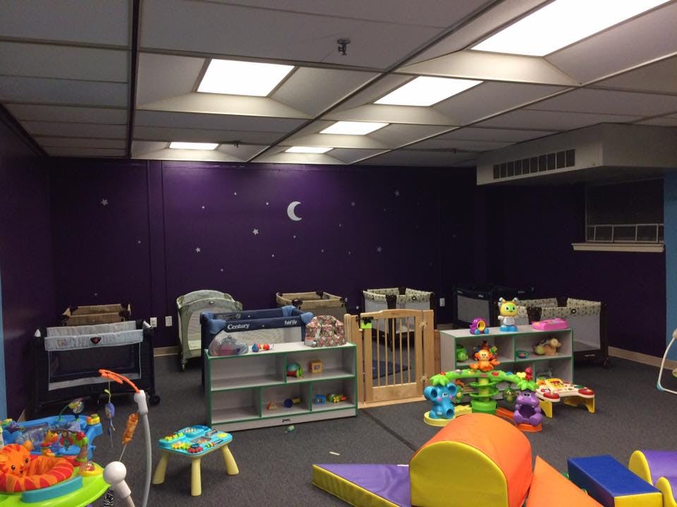 Nursery room with cribs, playpens, and toys
