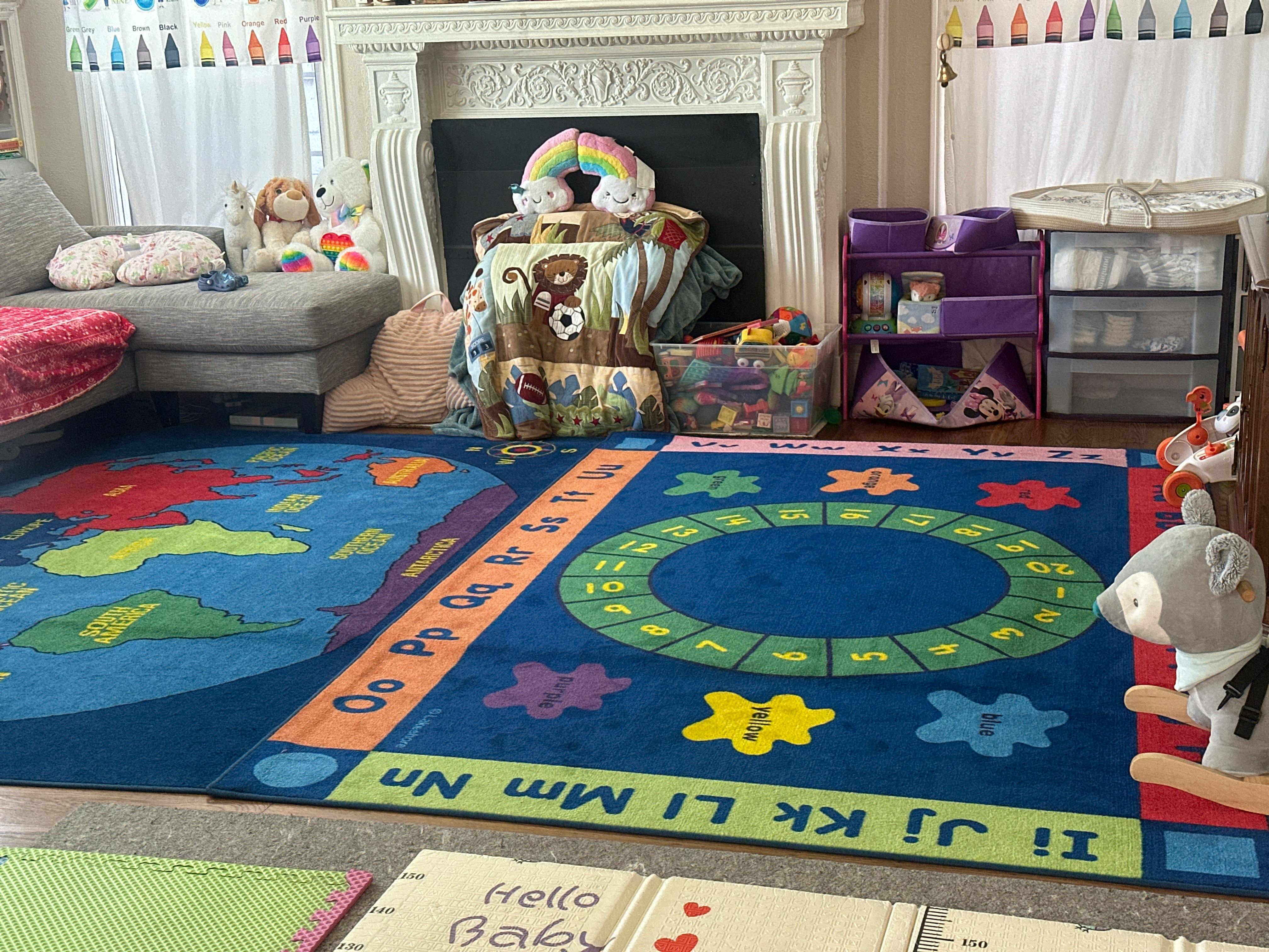 Playroom with alphabet rug and various toys