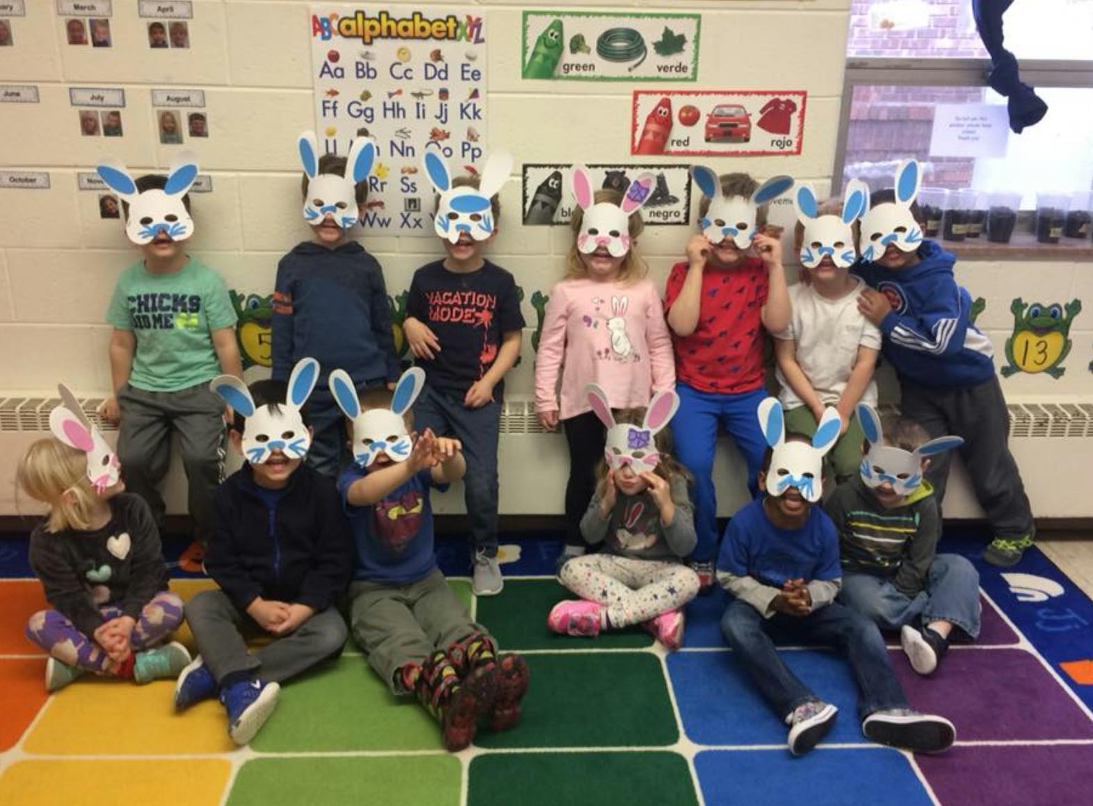 Group of children wearing bunny masks in a classroom