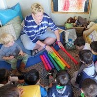 Adult showing colorful tubes to children
