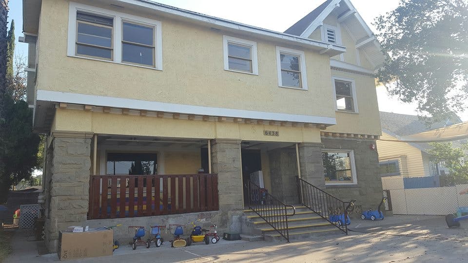 Two-story building with a porch and stairs