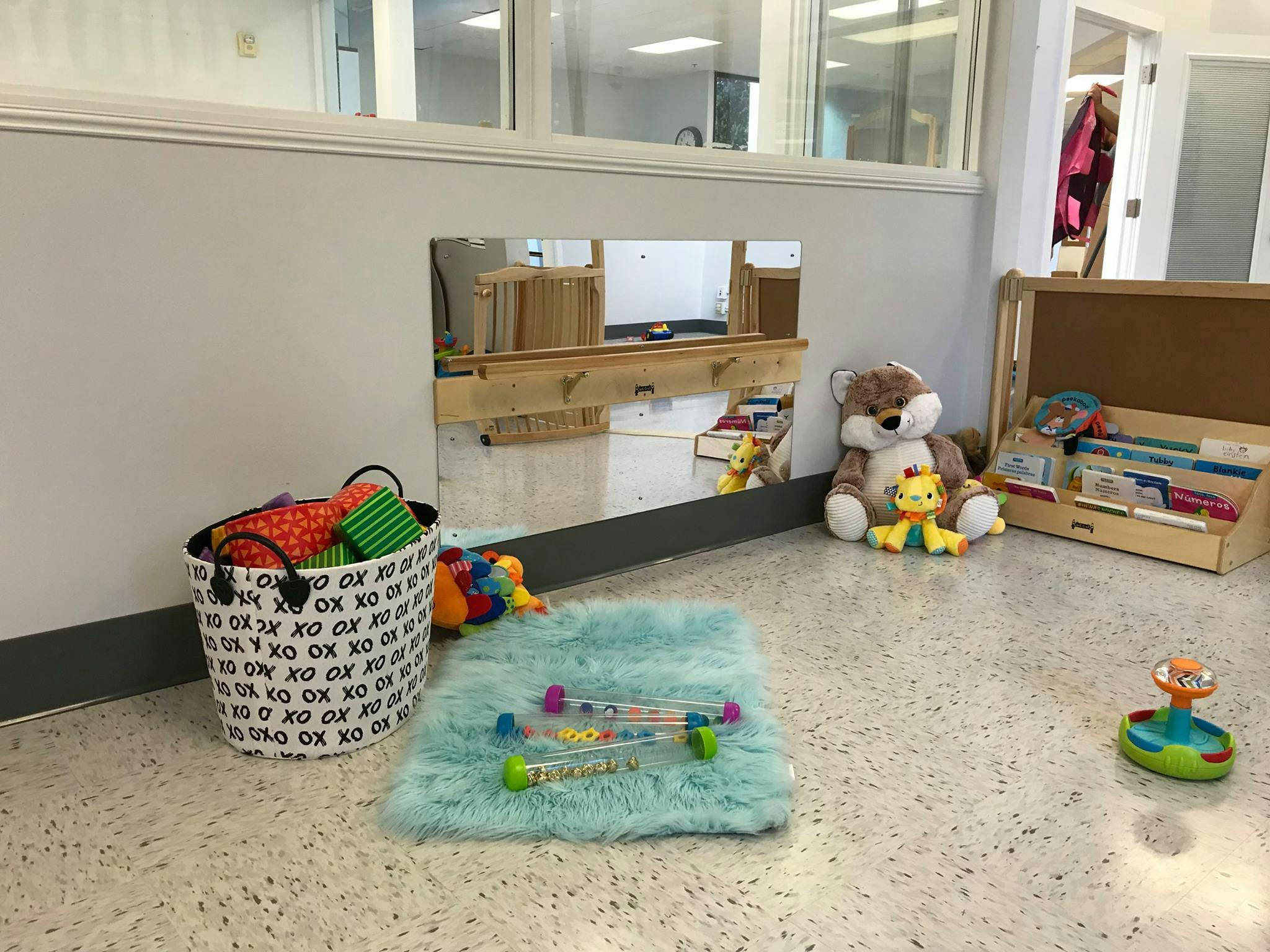 Playroom with toys, including a stuffed animal, basket, and rug