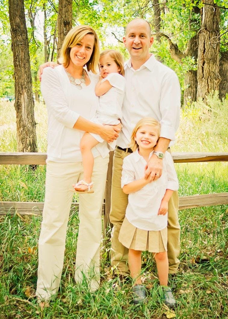 Two adults and two children standing outdoors
