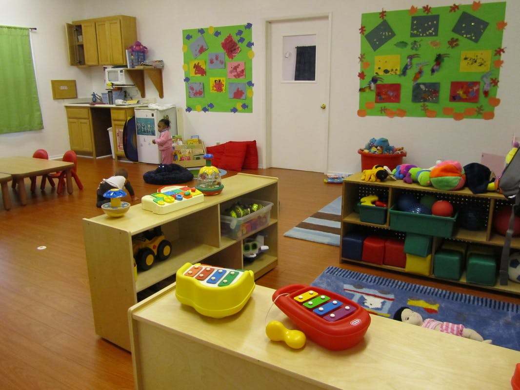 Child in a classroom with toys and shelves