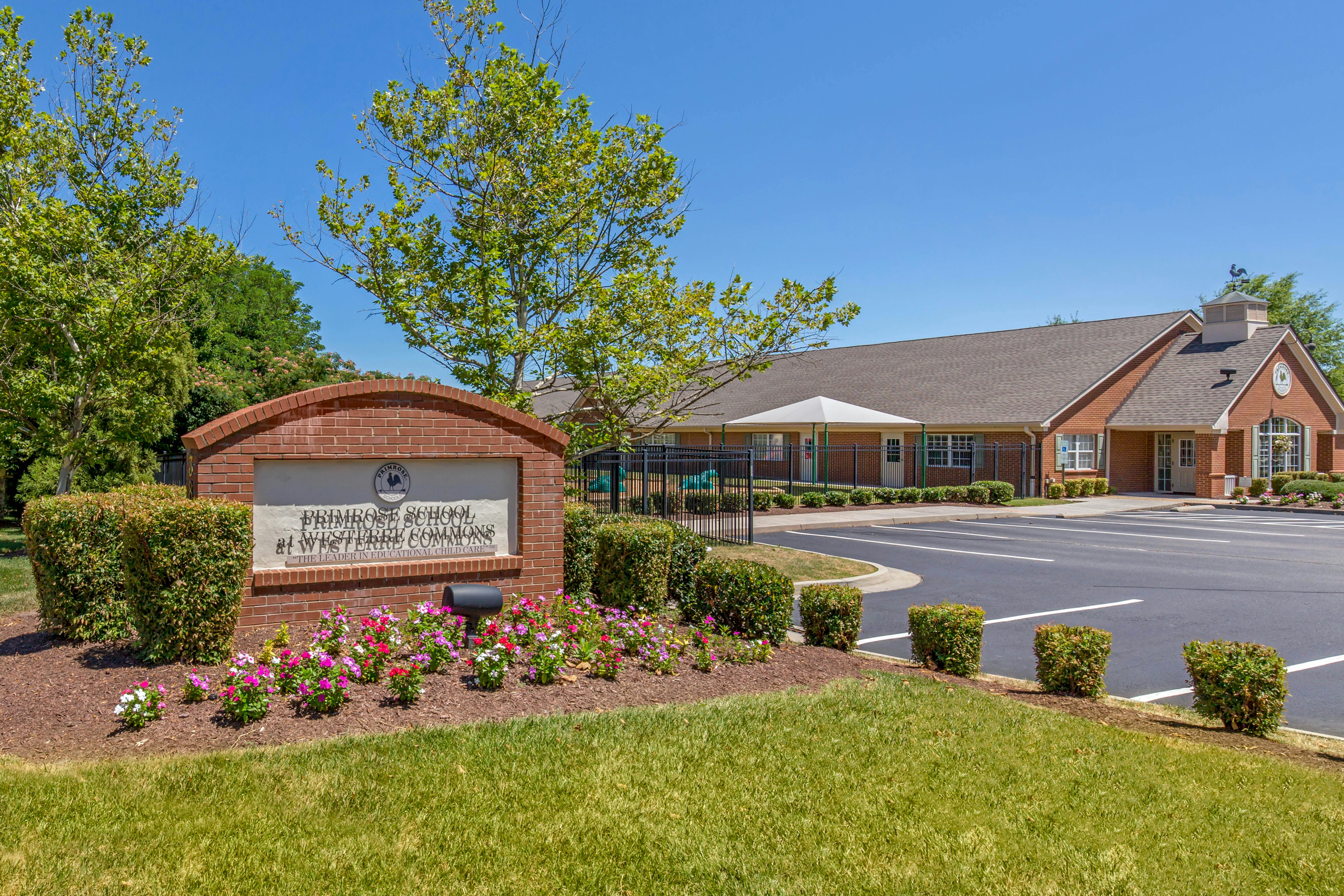 Primrose School sign in front of a brick building and parking lot