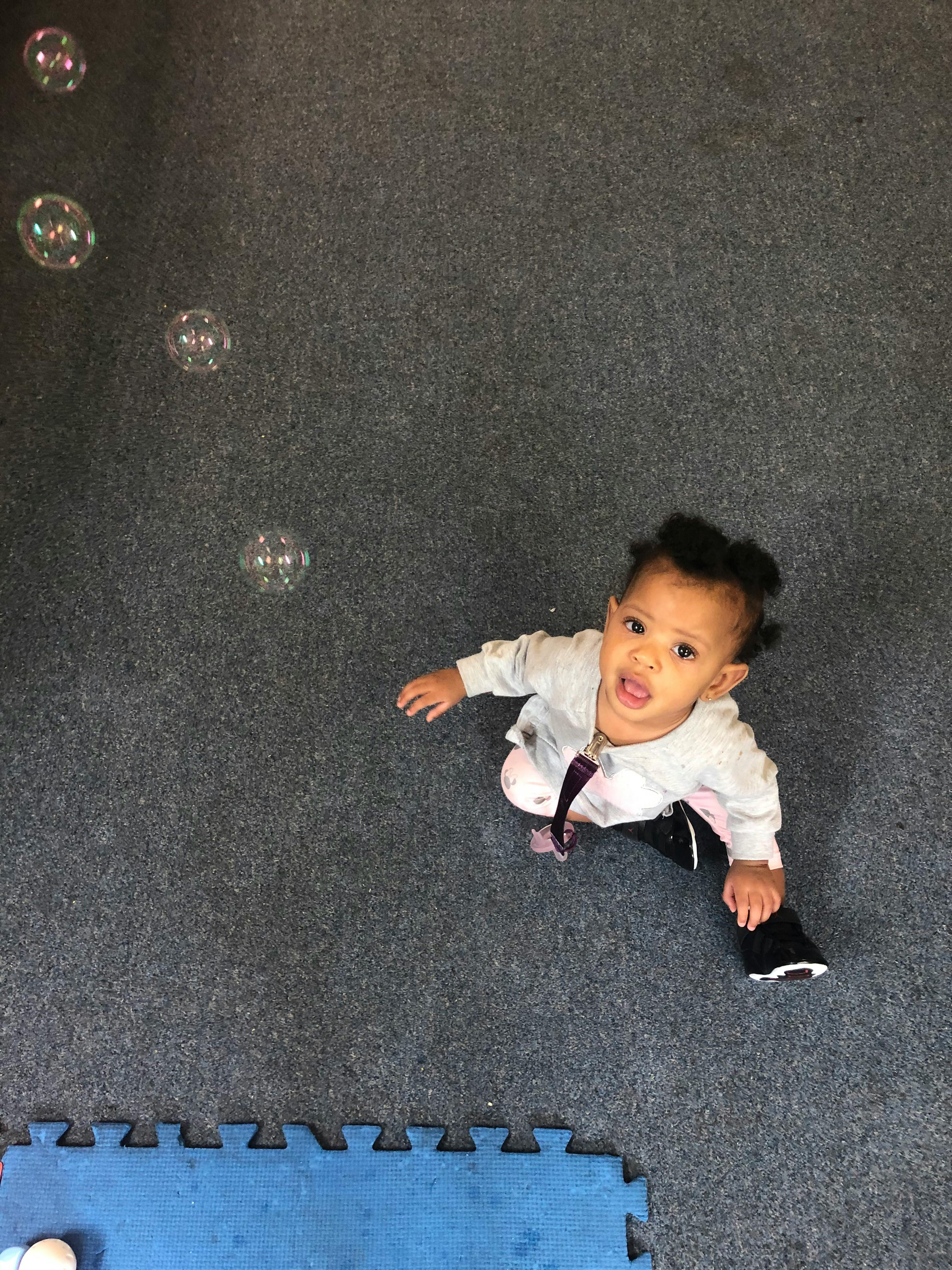 Child looking up at bubbles
