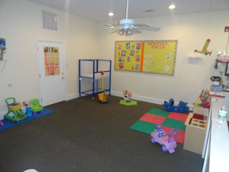 Playroom with toys, crib, and bulletin board