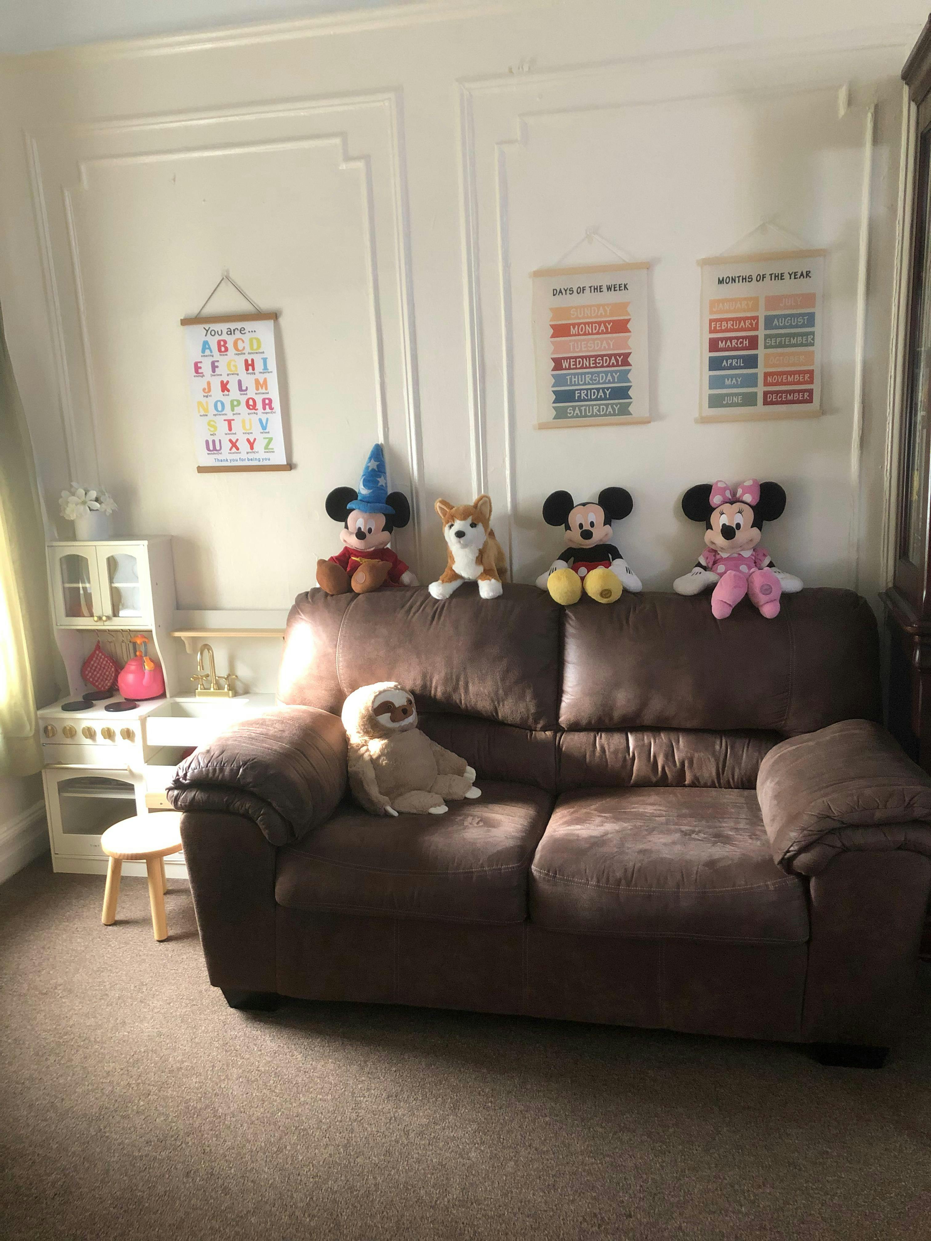 Stuffed animals on a brown couch