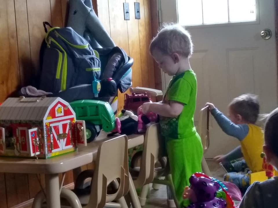 Child playing with toys at a small table