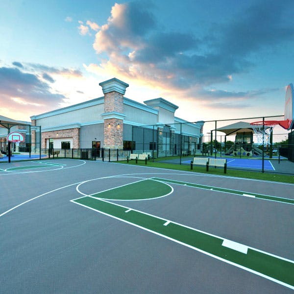 Outdoor basketball court with a building in the background