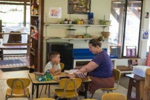 Adult and child sitting at a table