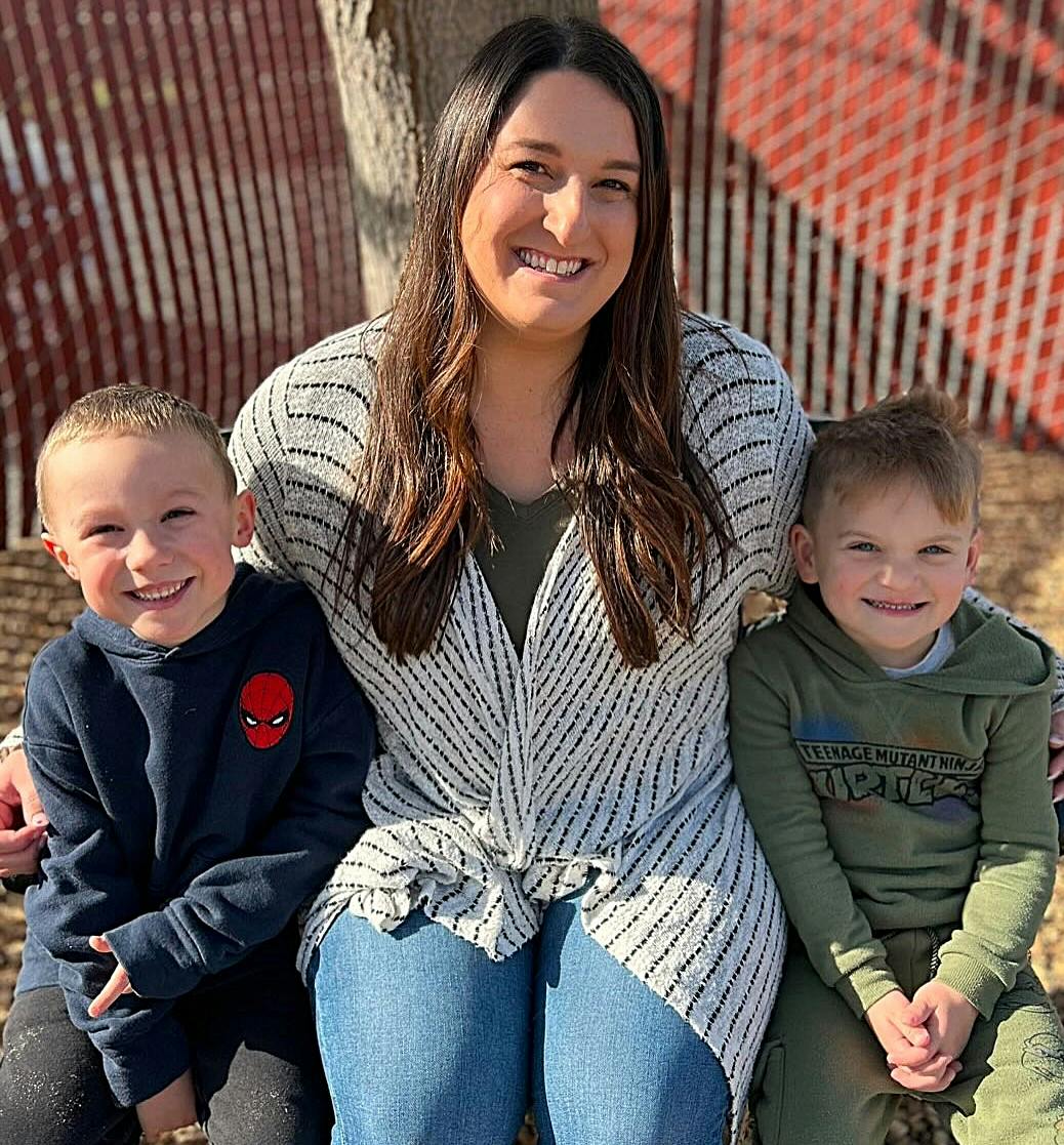 Person sitting with two children
