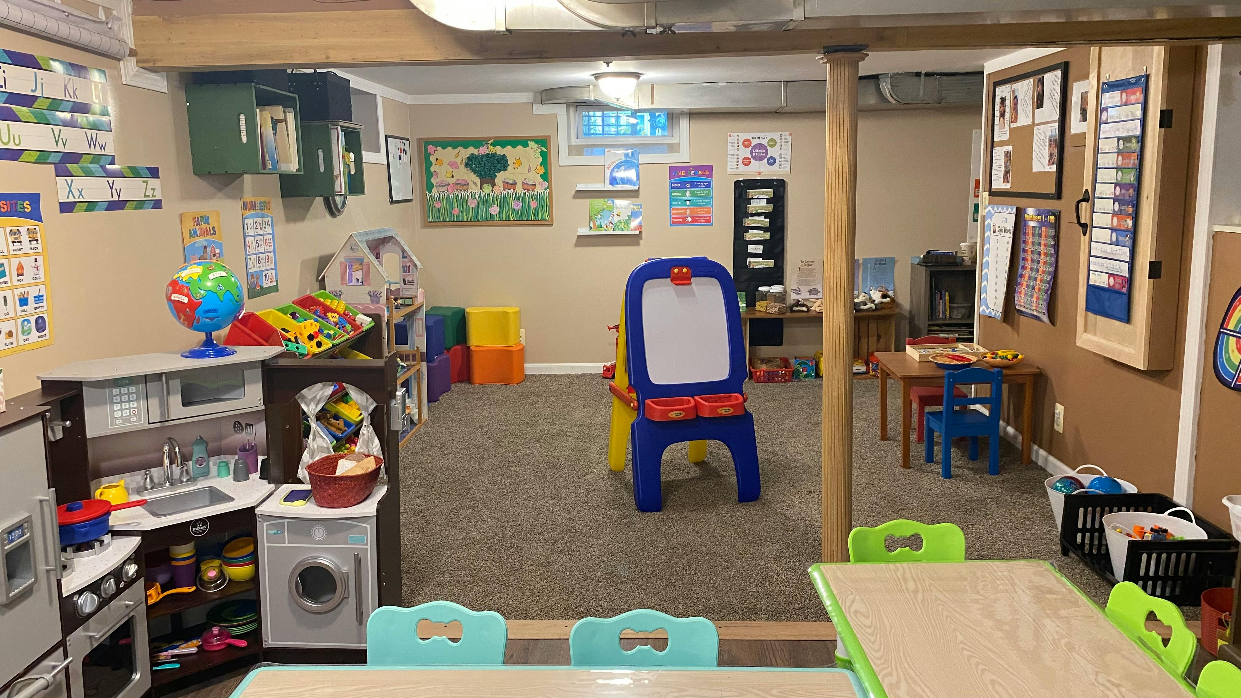 Playroom with various toys, small tables, and chairs