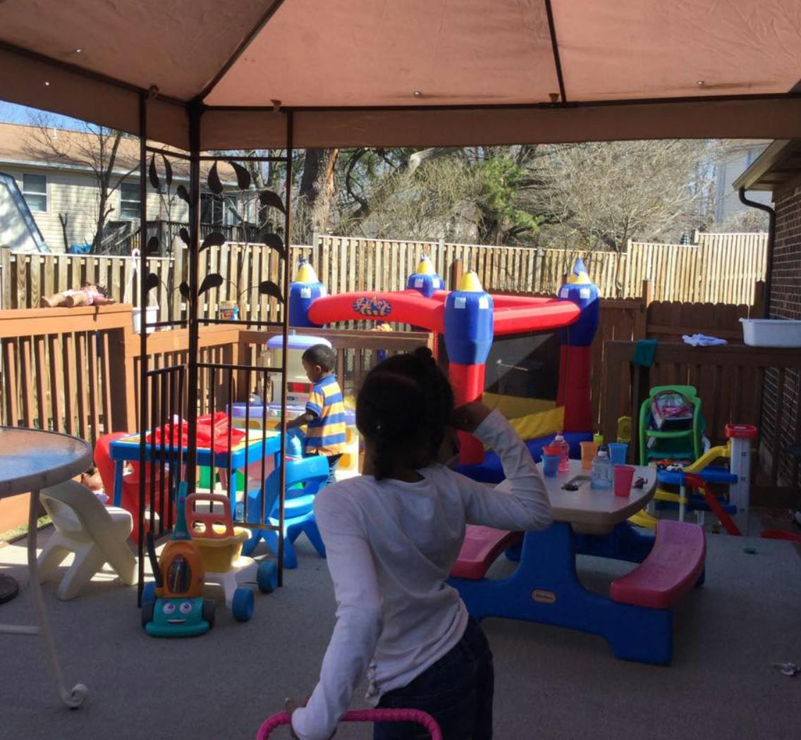 Two children playing with toys on a patio